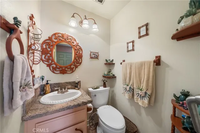 a bathroom with a toilet a sink and a mirror