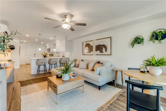 a living room with furniture potted plant and a chandelier