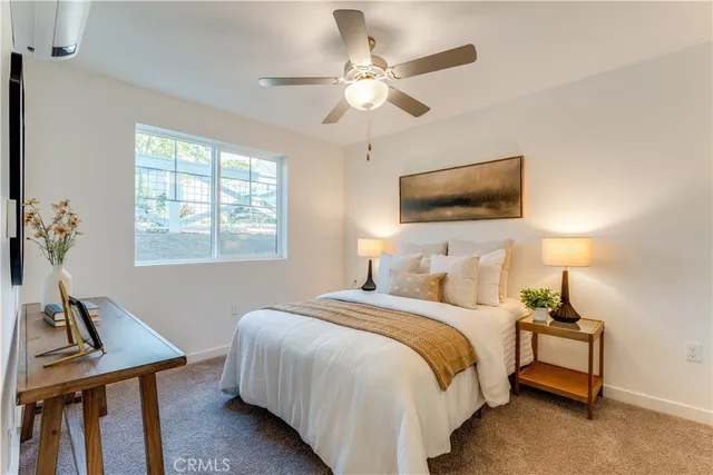 a kitchen with stainless steel appliances granite countertop a refrigerator a stove and a wooden cabinets