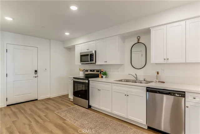 a kitchen with stainless steel appliances granite countertop a stove and a sink