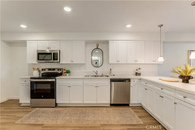 a kitchen with a sink stove and microwave