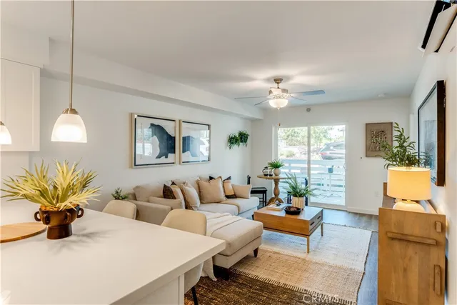 a living room with furniture potted plant and window