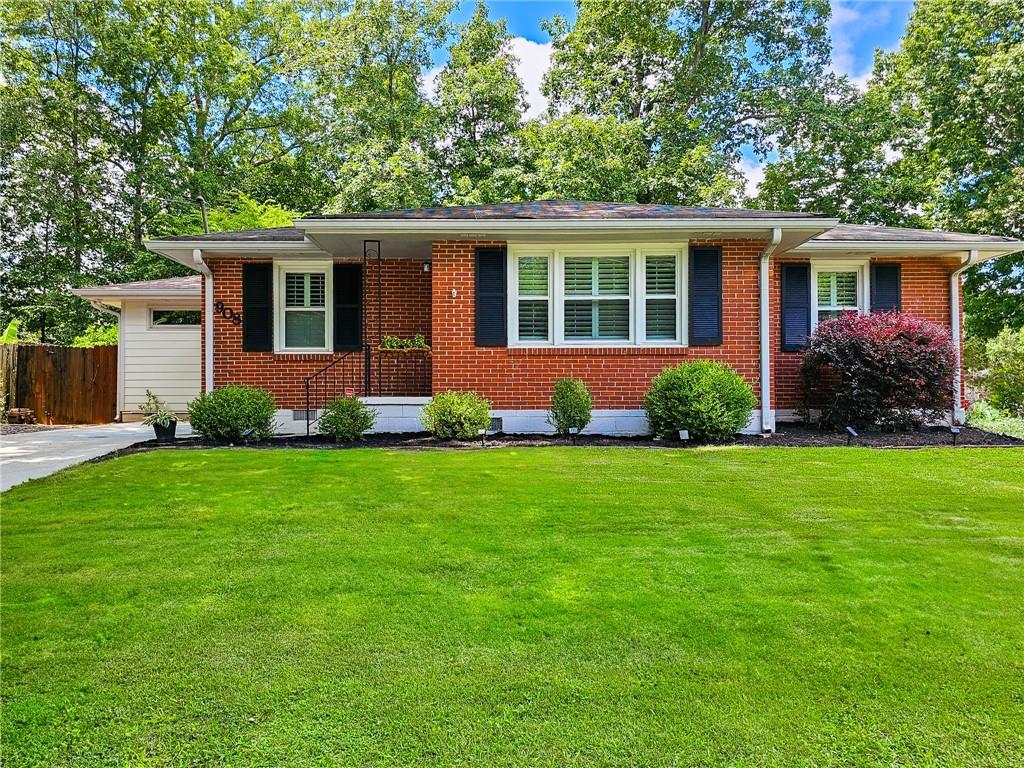 a front view of house with yard and green space