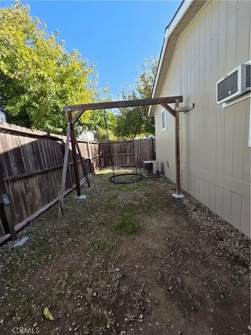 a view of a backyard with a wooden fence
