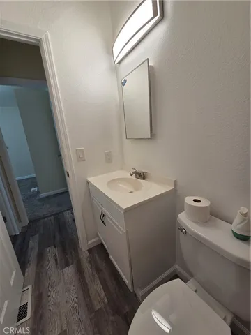 a bathroom with a sink mirror vanity and toilet