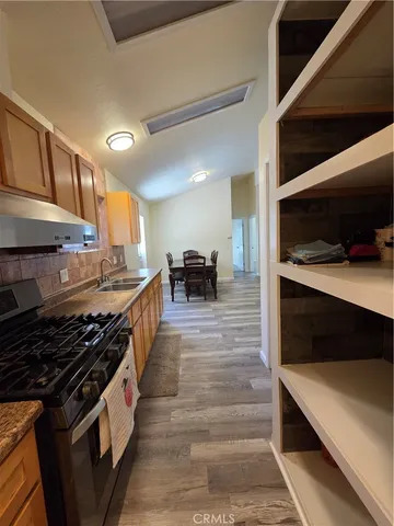 a kitchen with stainless steel appliances a stove and cabinets