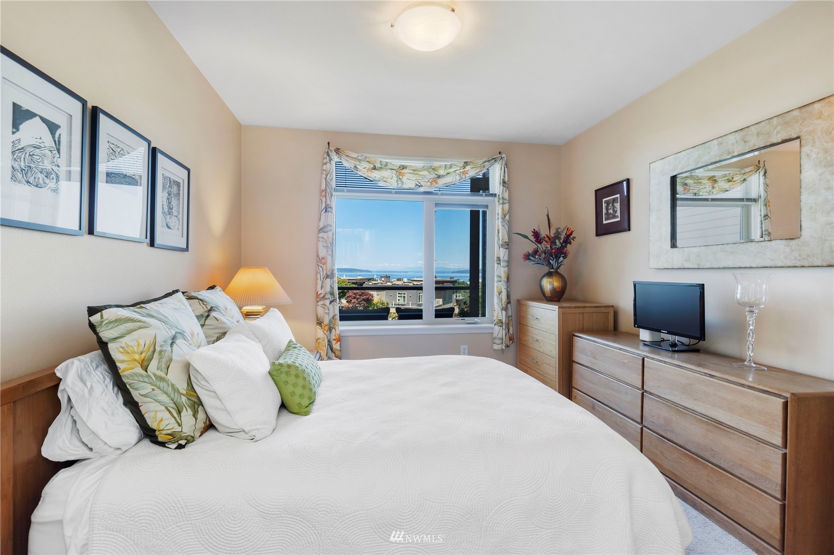75 Pine Street, Unit 205 Edmonds, WA 98020 - Photo 18 of 33 a bedroom with a bed and a flat screen tv