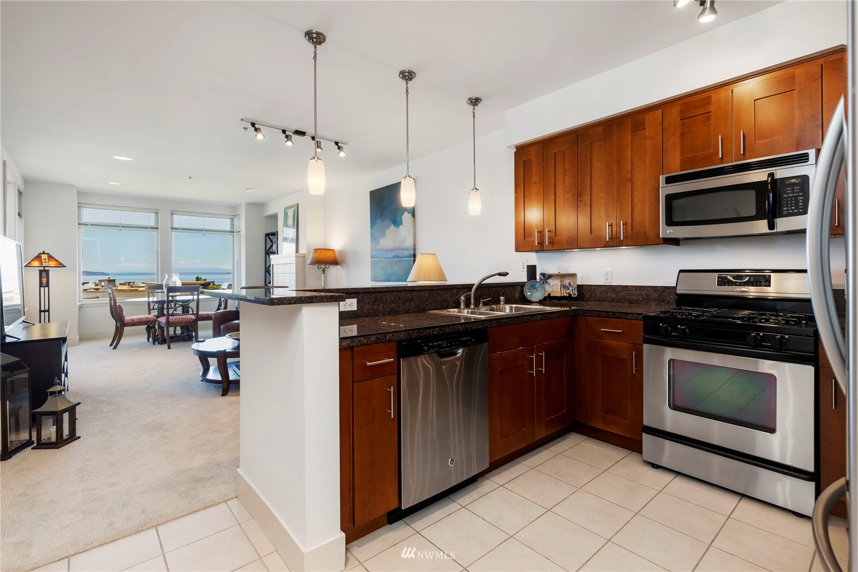 75 Pine Street, Unit 205 Edmonds, WA 98020 - Photo 5 of 33 a kitchen with stainless steel appliances granite countertop a stove a sink and a microwave