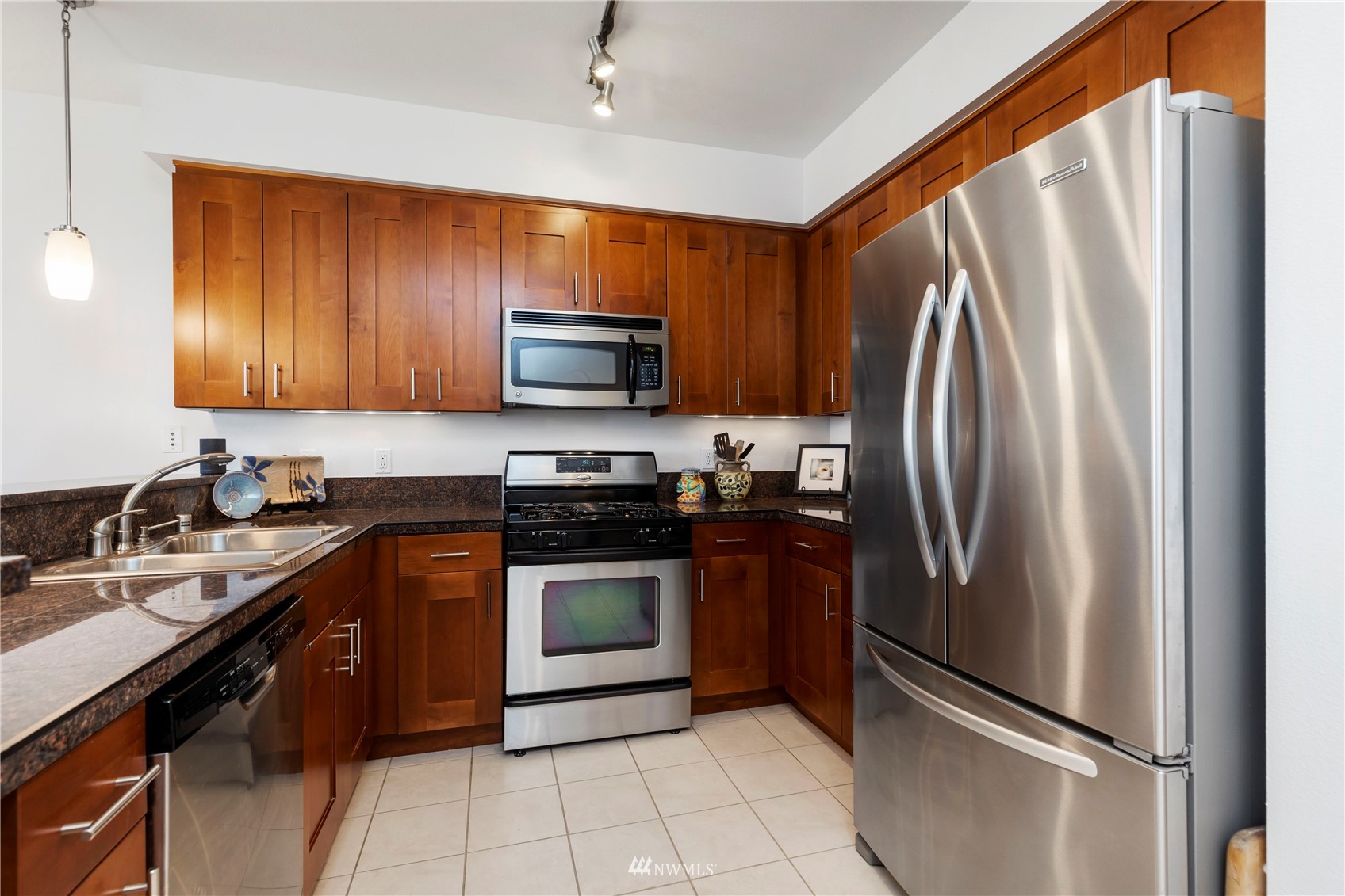 75 Pine Street, Unit 205 Edmonds, WA 98020 - Photo 6 of 33 a kitchen with stainless steel appliances granite countertop a refrigerator stove and sink