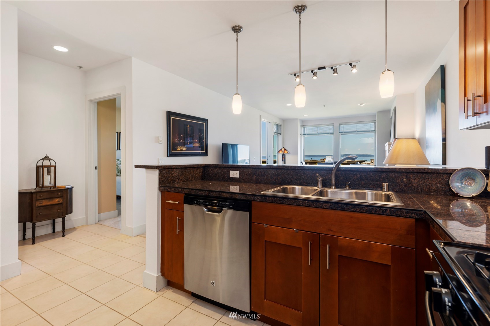 75 Pine Street, Unit 205 Edmonds, WA 98020 - Photo 7 of 33 a kitchen with kitchen island granite countertop a sink and a stove