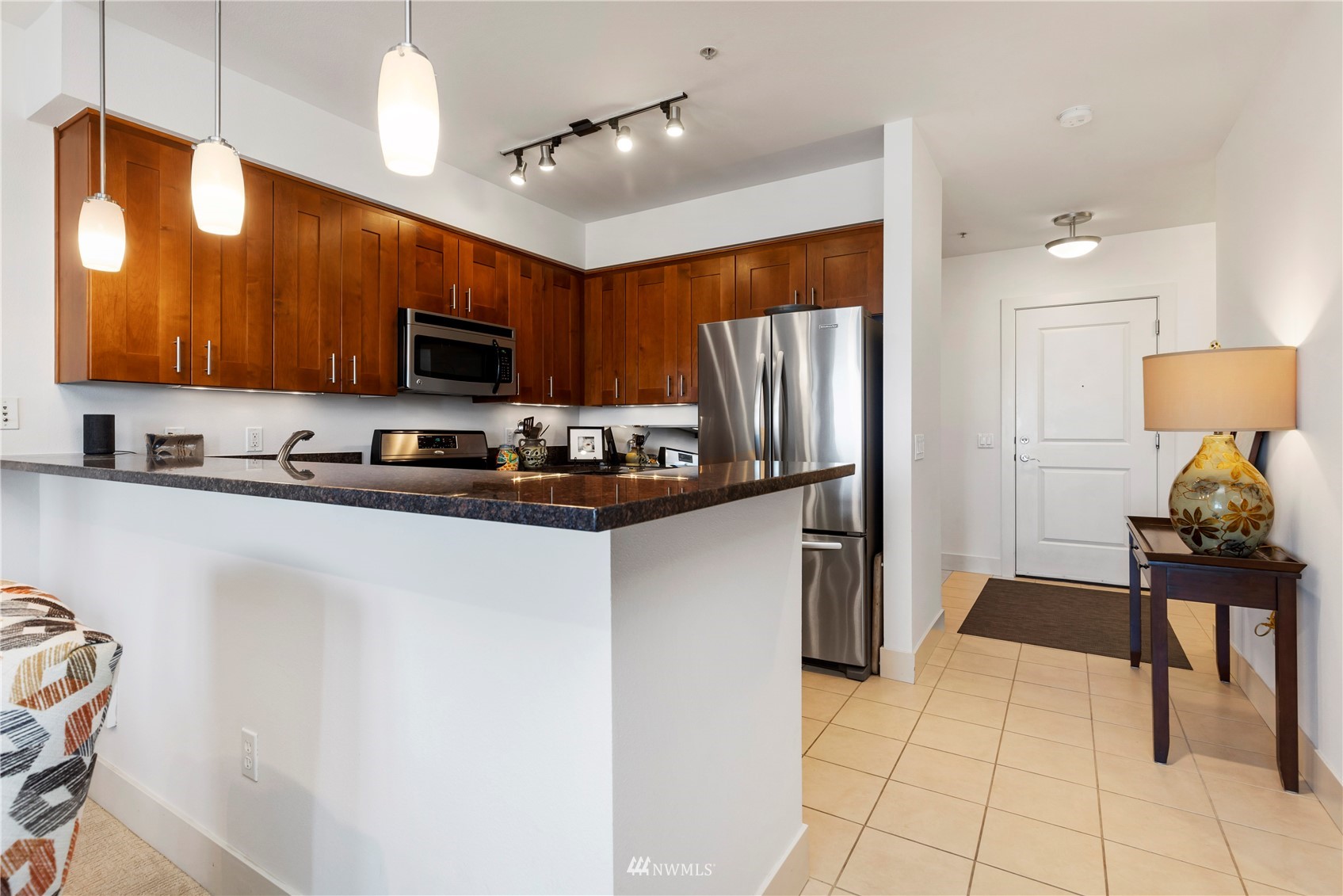75 Pine Street, Unit 205 Edmonds, WA 98020 - Photo 8 of 33 a kitchen with a refrigerator and a stove top oven