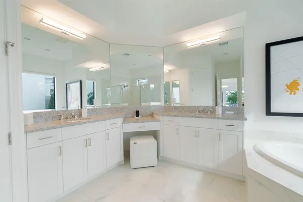 a kitchen with granite countertop white cabinets stainless steel appliances and sink