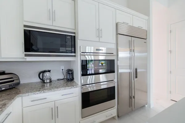 a bedroom with a bed and a flat tv screen on a dresser