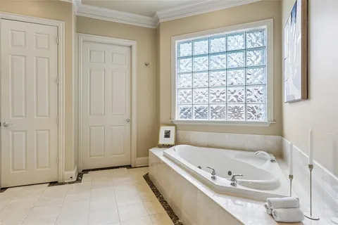 a bathroom with a tub and a window