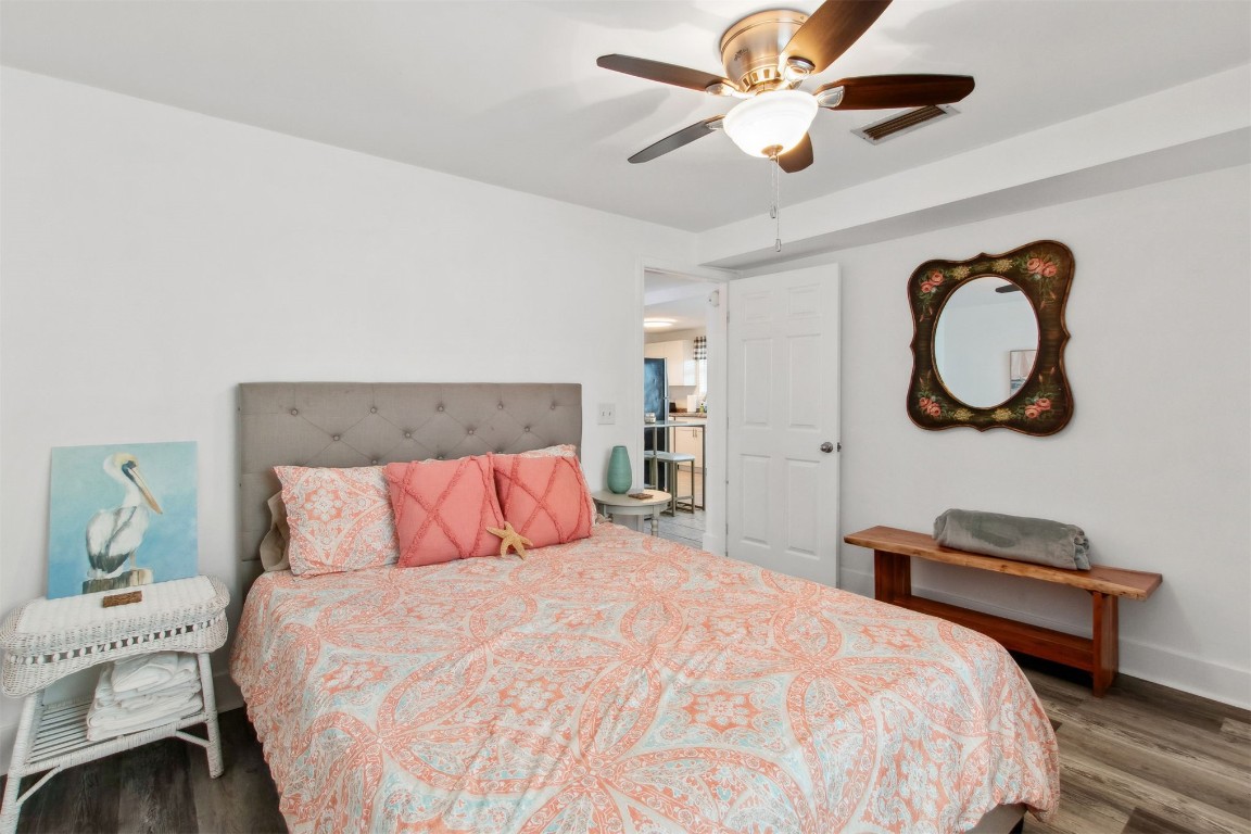 729 North Fletcher Avenue Fernandina Beach, FL 32034 - Photo 11 of 25 a bedroom with a bed and a chandelier