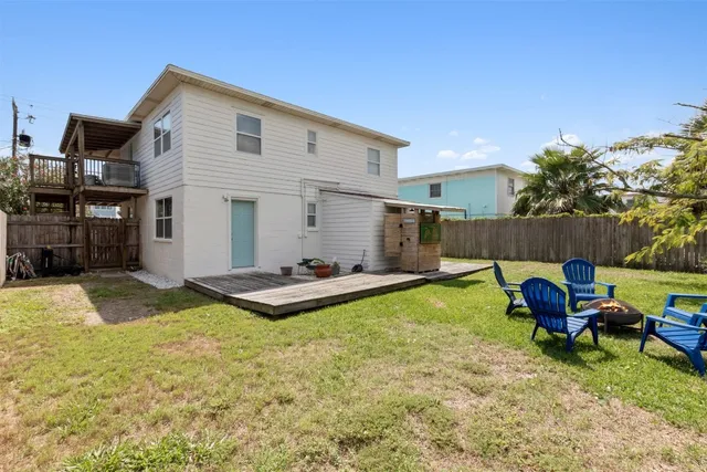 a swimming pool with outdoor seating and yard