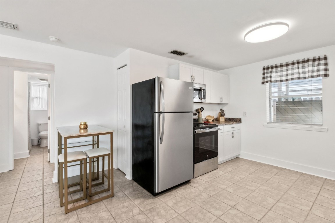729 North Fletcher Avenue Fernandina Beach, FL 32034 - Photo 8 of 25 a kitchen with granite countertop a refrigerator stove top oven and sink