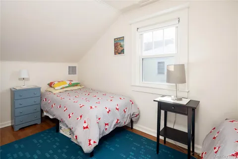 a bedroom with a bed and a dresser in it