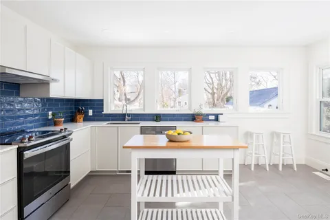 a kitchen with a stove a sink and a microwave
