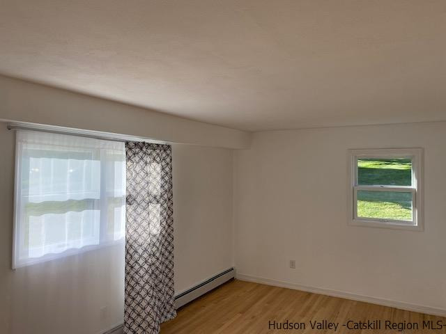 4 Gate Road Highland, NY 12528 - Photo 6 of 28 a view of an empty room with wooden floor and a window