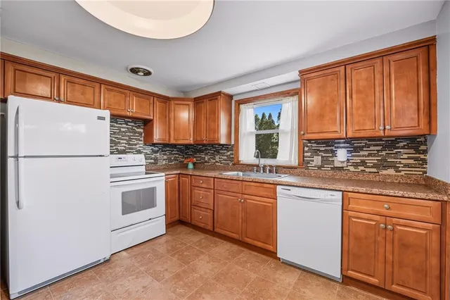 a kitchen with granite countertop cabinets stainless steel appliances and a sink