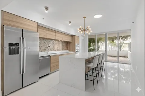a kitchen with a table and chairs