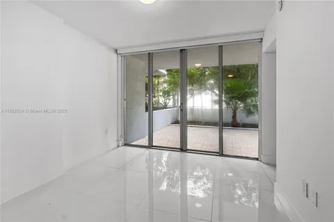a view of an empty room with glass door