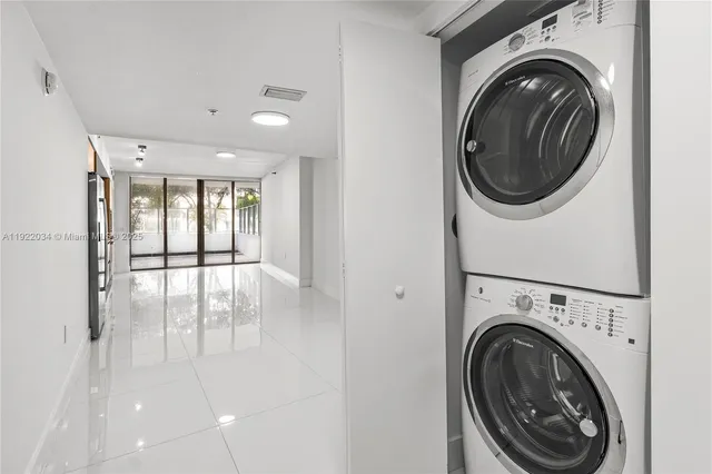 a view of a hallway with washer and dryer