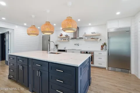 a bedroom with a large bed and a potted plant