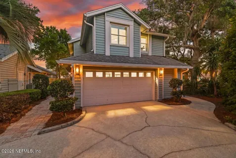 a view of a house with backyard and garden
