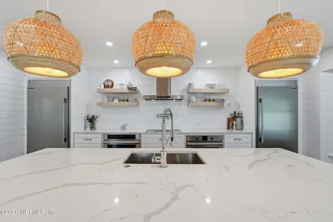 a bathroom with a sink vanity granite and a mirror