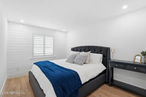 a view of a dining room with furniture large windows and wooden floor