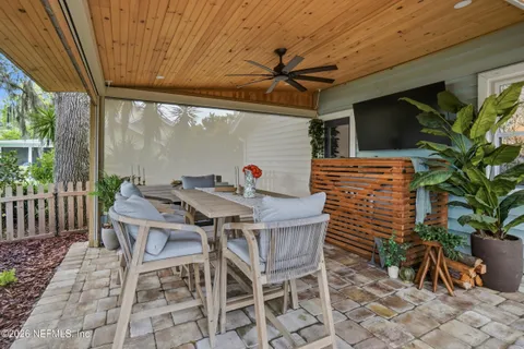 a green field with lots of trees in the background