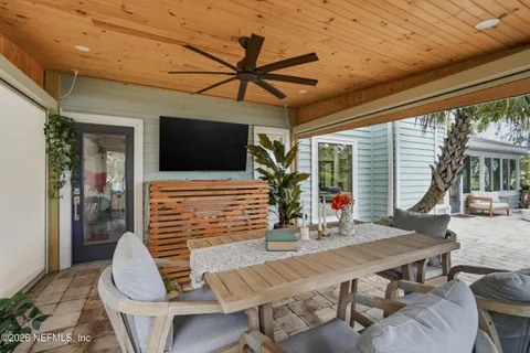an aerial view of ocean and residential houses with outdoor space