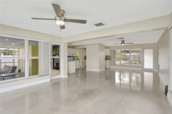 a kitchen with stainless steel appliances granite countertop a sink a stove and white cabinets