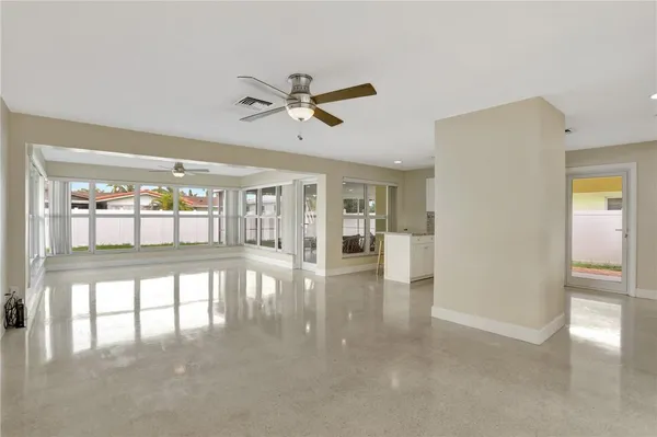a view of a livingroom with a ceiling fan and window