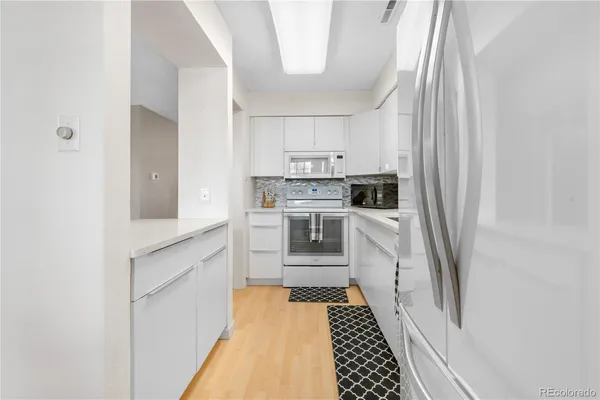 a kitchen with appliances cabinets and a sink