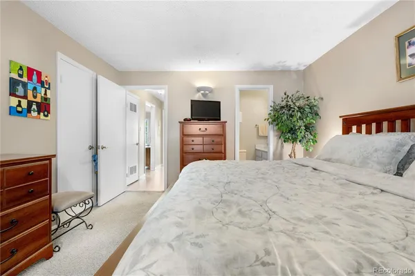 a bedroom with a bed and a dresser