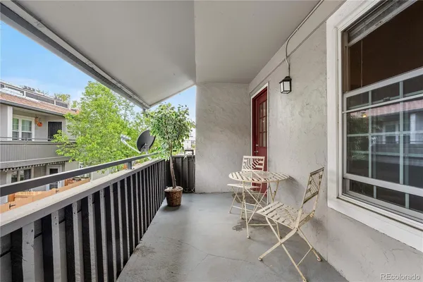 a dining room with furniture and front door