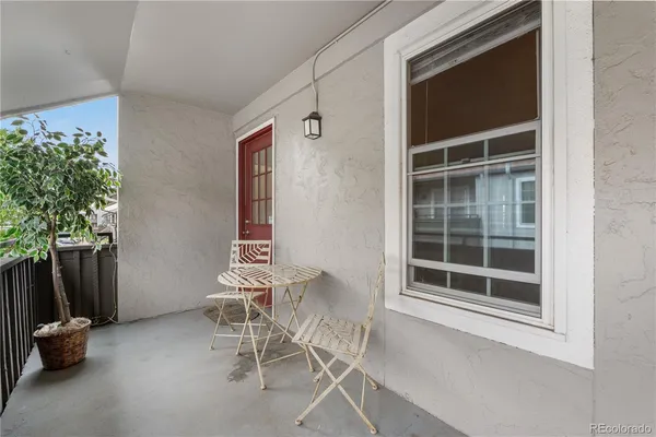 a view of a chair and table in the balcony