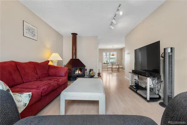 a living room with furniture and a lamp