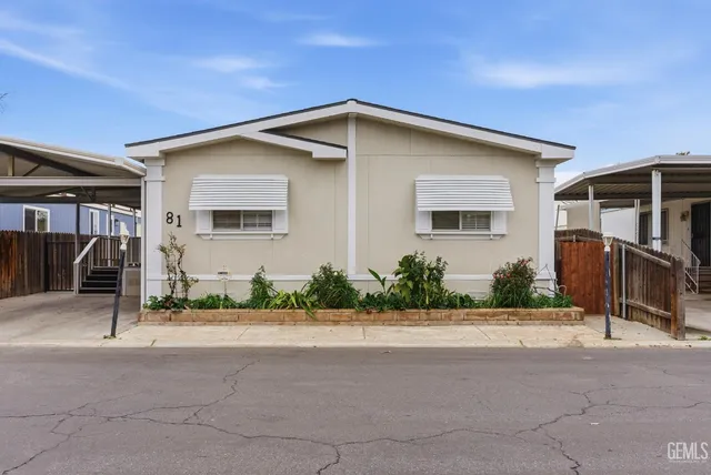 a front view of house along path and glass door