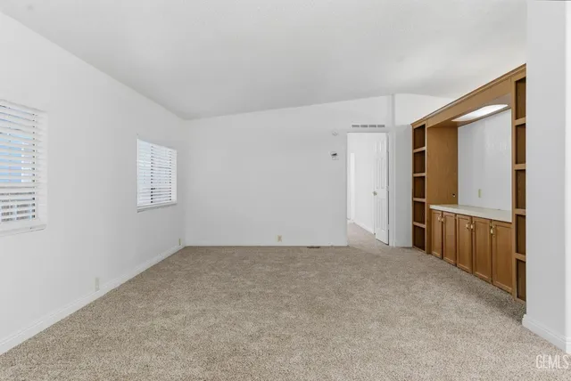 a view of a big room with windows and wardrobe