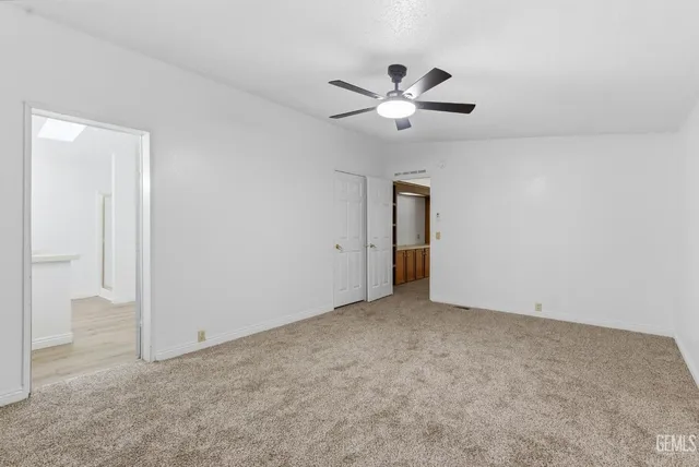 a view of an empty room with a fan