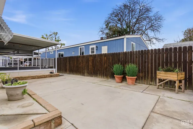 a backyard of a house with table and chairs