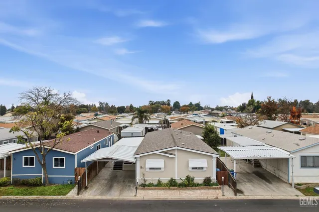 an aerial view of residential houses with city view