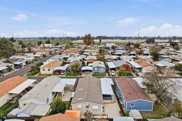 an aerial view of residential houses with city view