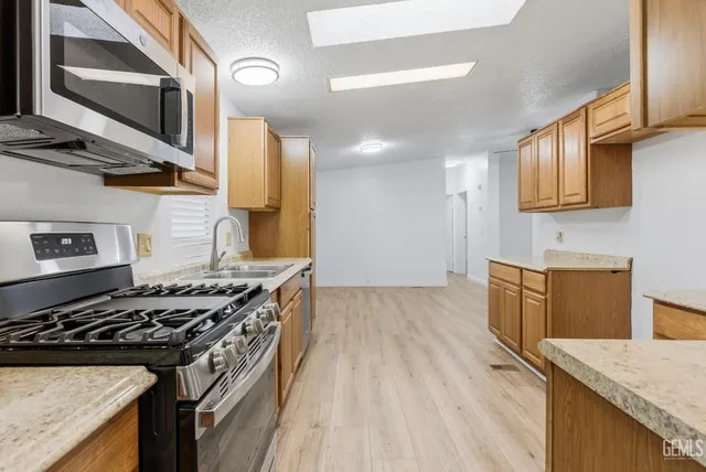 a kitchen with stainless steel appliances granite countertop a stove and a sink