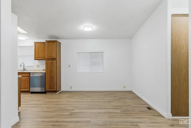 a view of kitchen with refrigerator and microwave