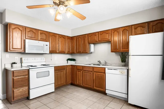 a kitchen with a white cabinets and white appliances